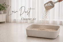 Cat litter being poured into a litter box with text 'Low Dust' and 'Cleaner air'.
